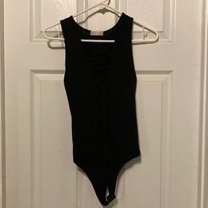 Cute body suit with criss cross design on chest